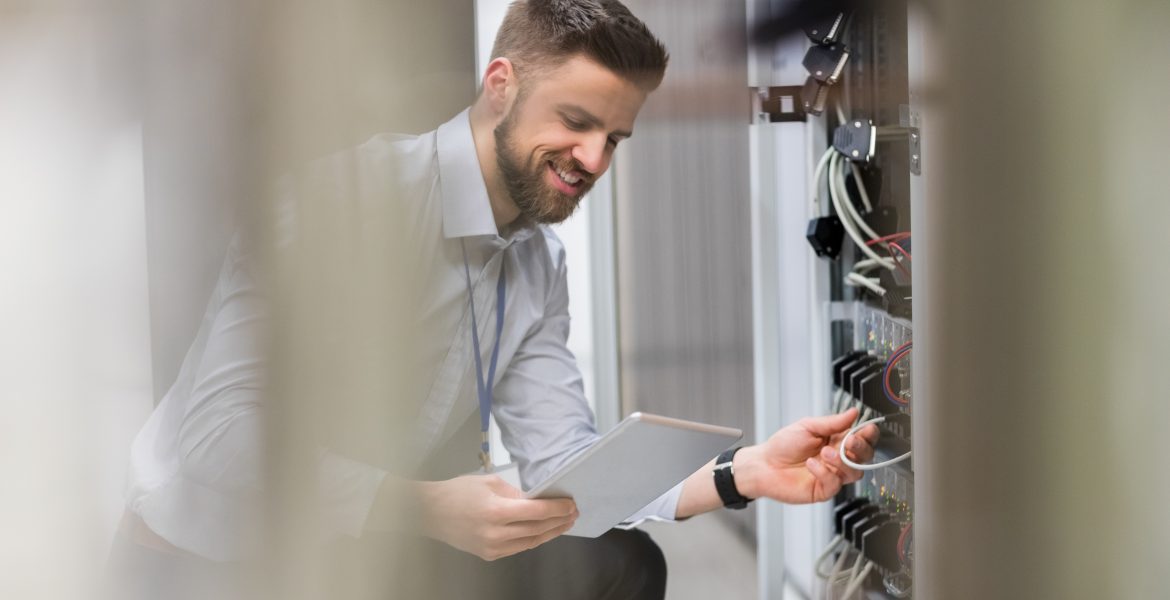Technician Using Digital Tablet While Analyzing Server