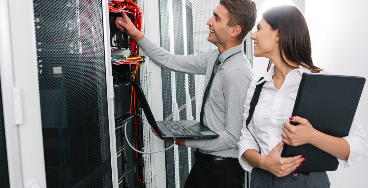 Team OF Young Business People IT Engineer IN Network Server Room Solving Problems AND Give Help AND Support